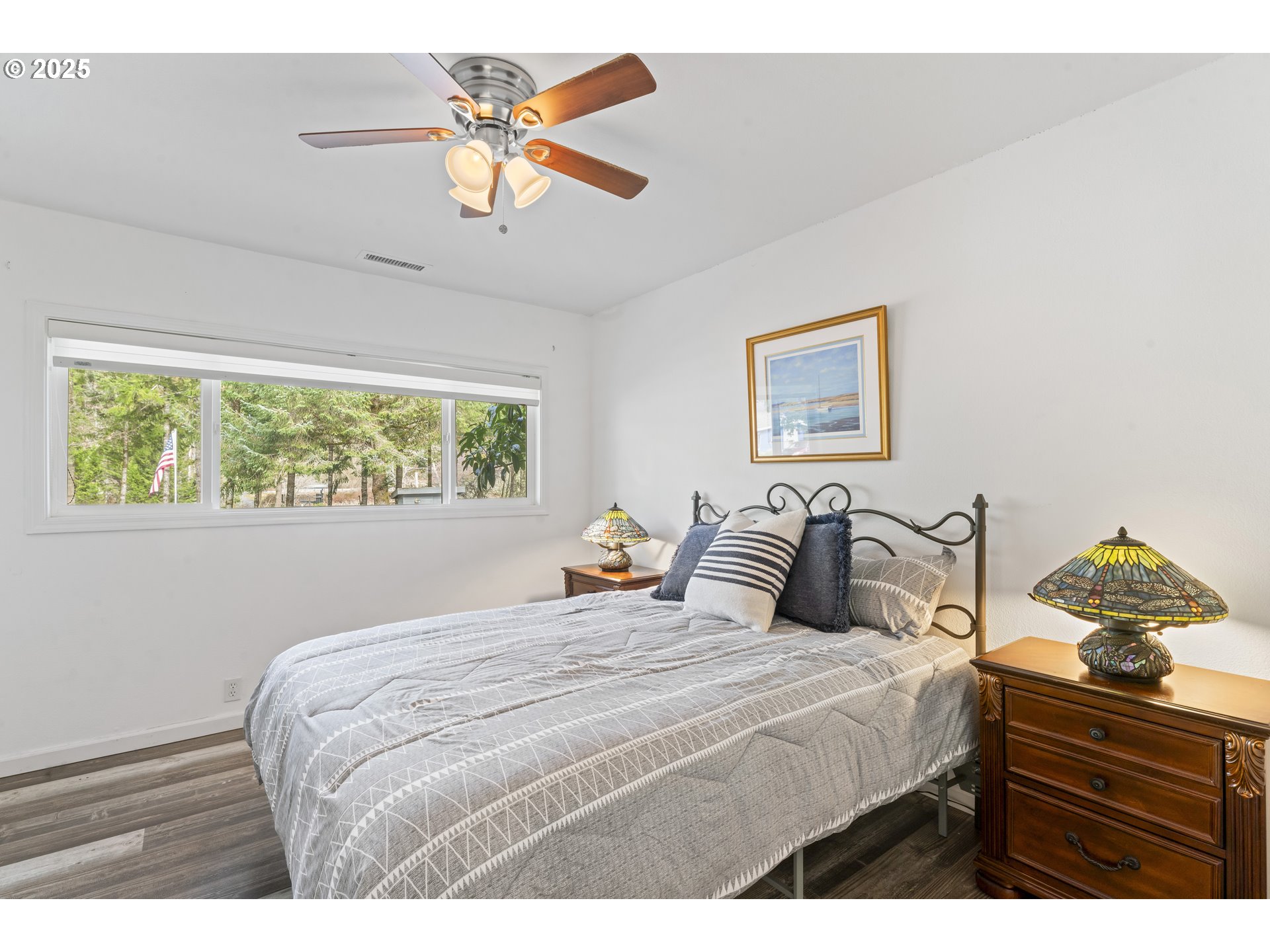 9202 Phey Lane Florence, OR 97439 - Photo 29 of 47 a bedroom with a large bed and a chandelier