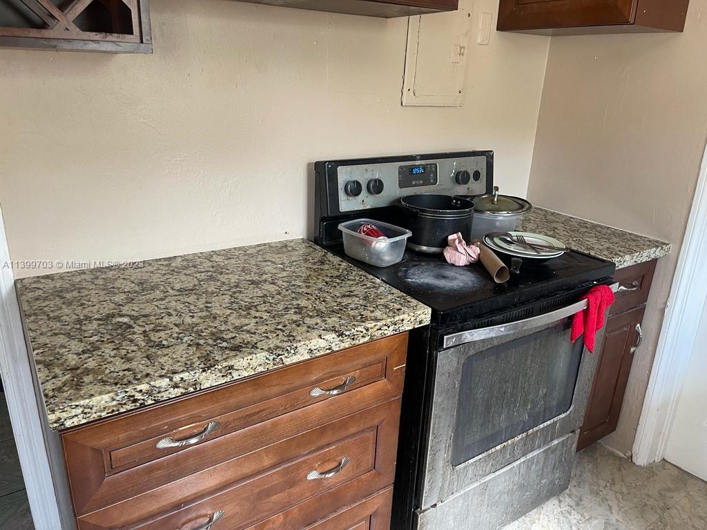 121 Northwest 53rd Street Miami, FL 33127 - Photo 3 of 5 a utility room with stove and cabinets