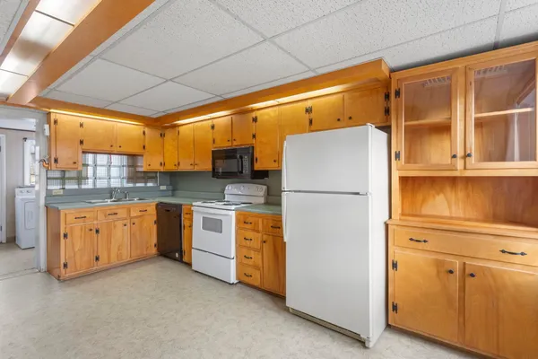 a kitchen with stainless steel appliances a refrigerator and cabinets