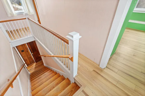 a view of entryway with wooden floor and door