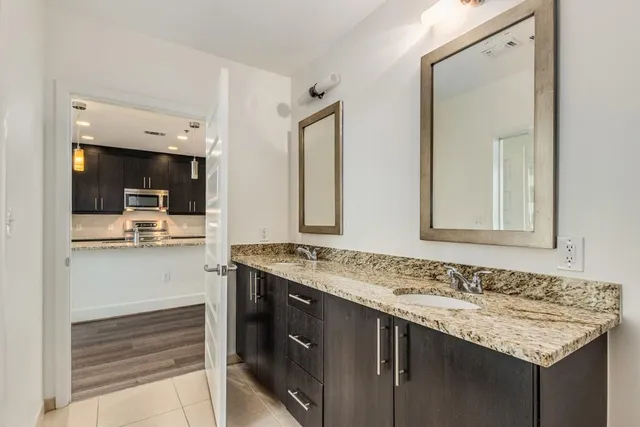 a view of a balcony with a floor to ceiling window next to a tall building