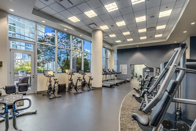 a view of a patio with couches and table and chairs next to a yard