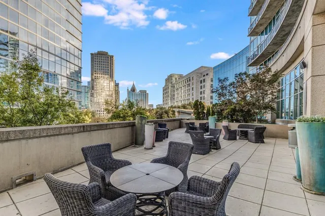 a view of a dining room with furniture and a potted plant