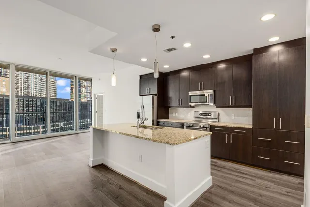 a view of a kitchen with a stove a sink and a refrigerator