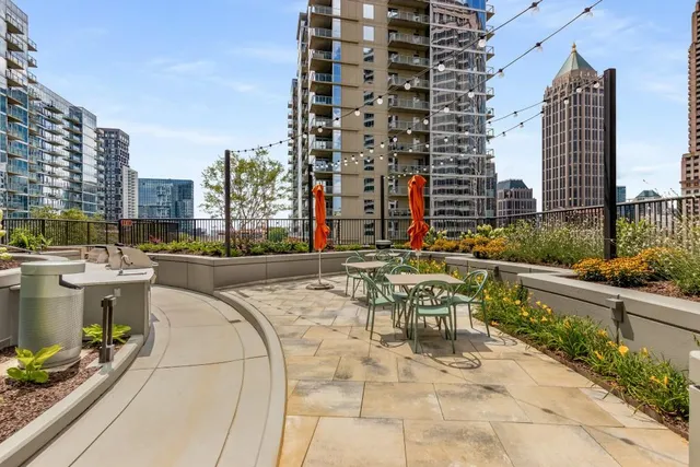 a view of a chairs and table in the back yard of the house