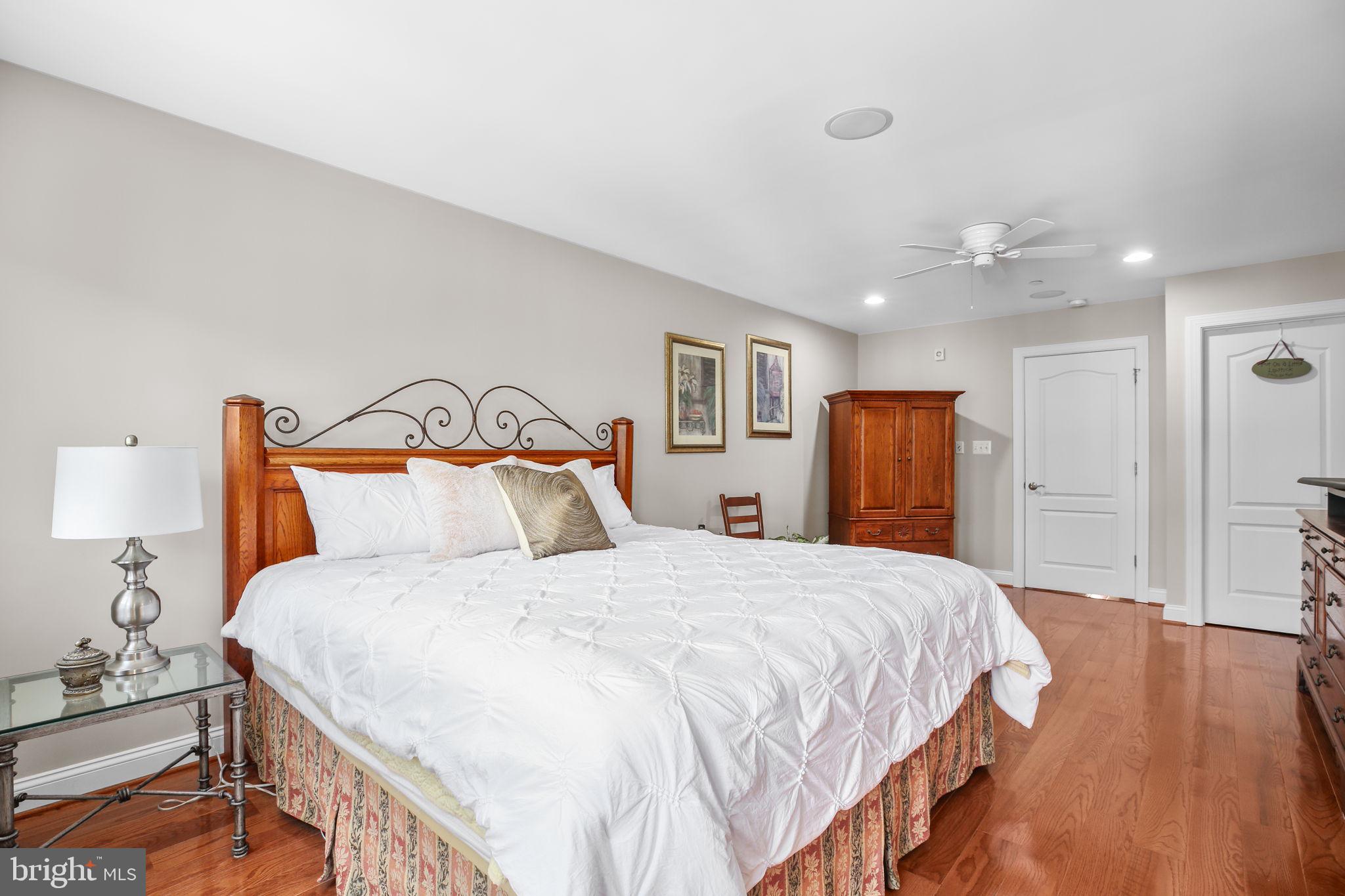 229 Mill Street Occoquan, VA 22125 - Photo 20 of 61 a bedroom with a bed and a lamp on dresser