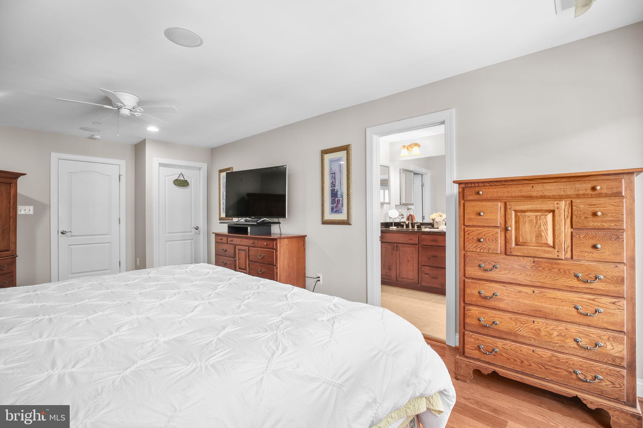 229 Mill Street Occoquan, VA 22125 - Photo 21 of 61 a large bedroom with a bed and a flat screen tv