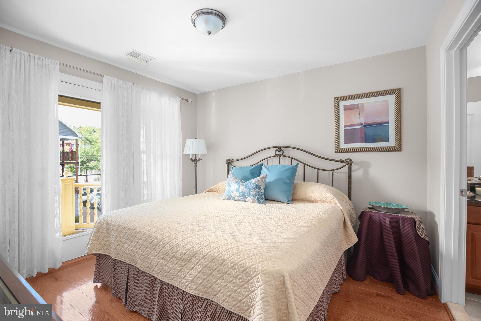 229 Mill Street Occoquan, VA 22125 - Photo 25 of 61 a bedroom with a bed and wooden floor