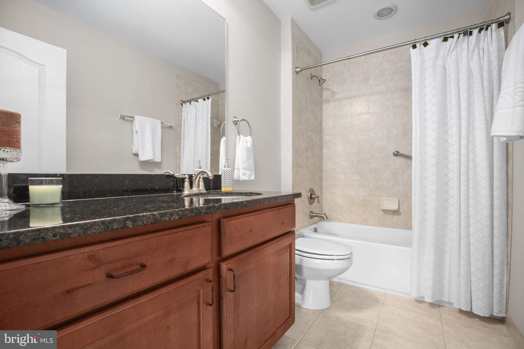 229 Mill Street Occoquan, VA 22125 - Photo 27 of 61 a bathroom with a double vanity sink toilet and shower