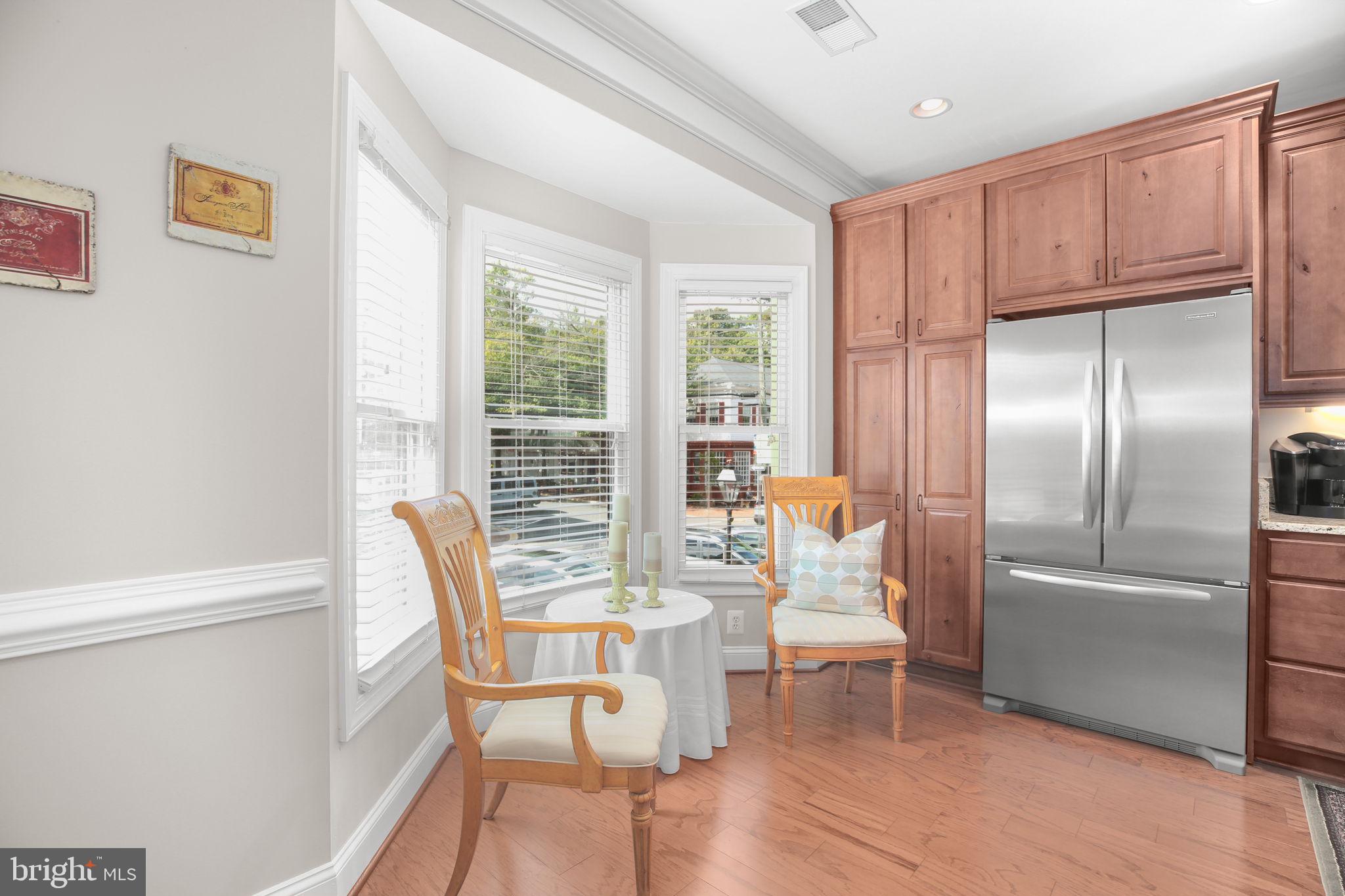 229 Mill Street Occoquan, VA 22125 - Photo 3 of 61 a dining room with furniture a chandelier and wooden floor