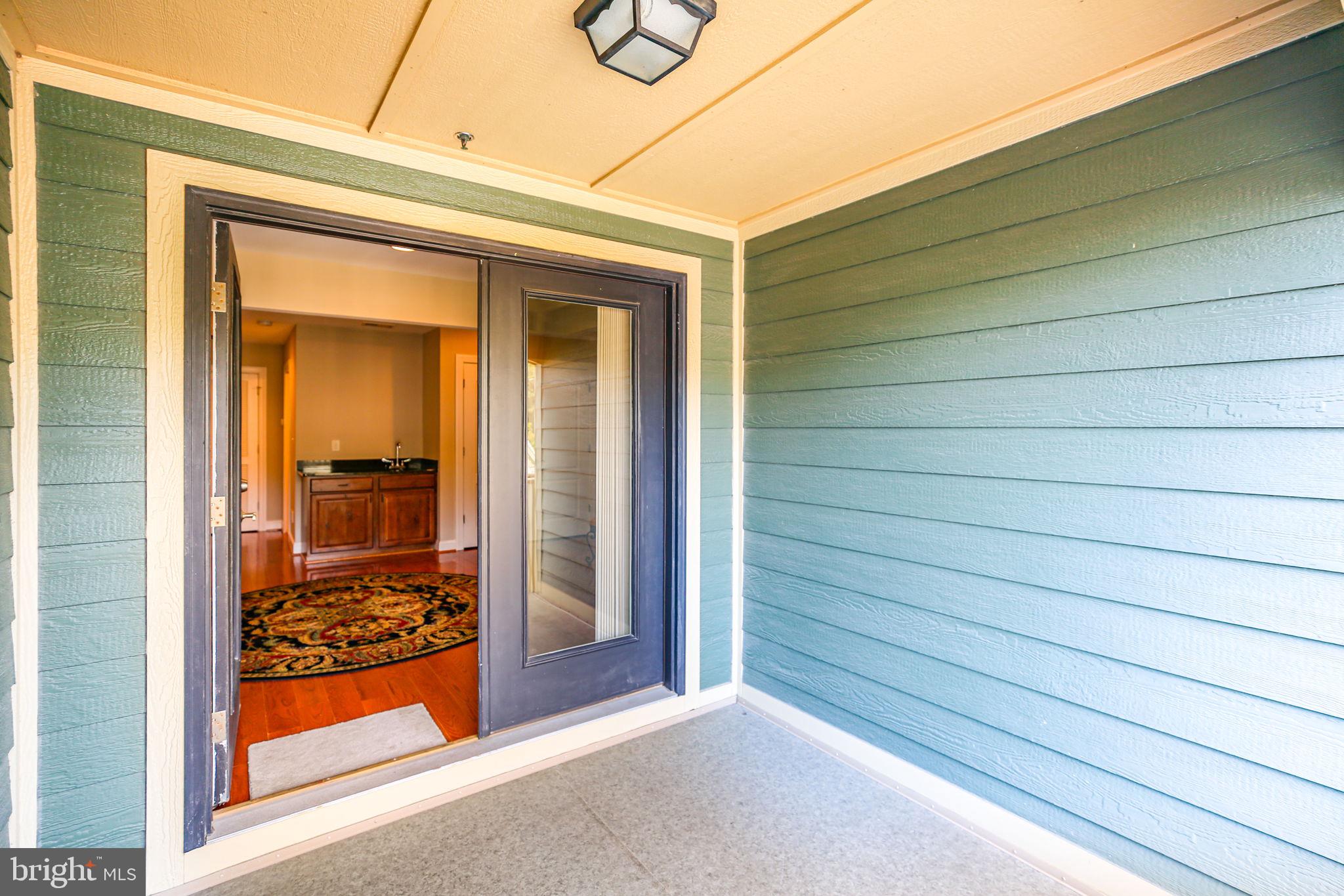 229 Mill Street Occoquan, VA 22125 - Photo 37 of 61 a view of a porch with a door and wooden floor