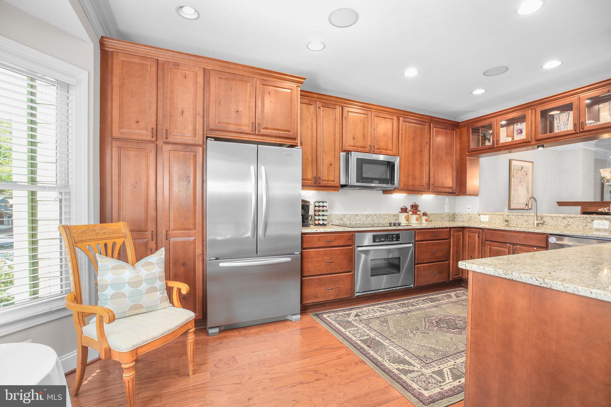 229 Mill Street Occoquan, VA 22125 - Photo 4 of 61 a kitchen with stainless steel appliances granite countertop a refrigerator and a stove top oven