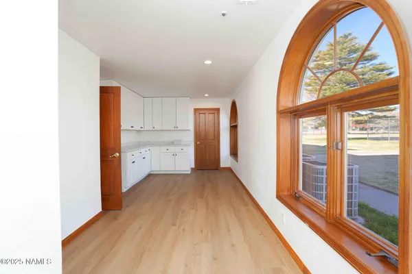 a bathroom with a granite countertop toilet sink mirror and vanity