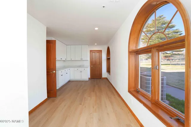 a bathroom with a granite countertop toilet sink mirror and vanity