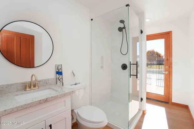 a view of an empty room with a window and a ceiling fan