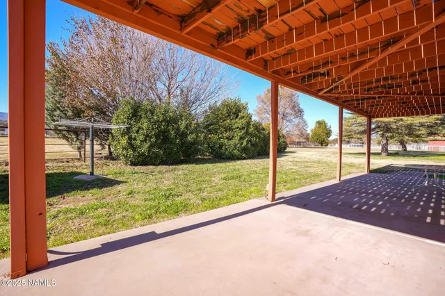 a view of an empty room with a fireplace and a window