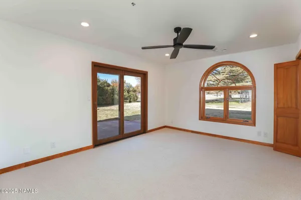 a view of an empty room with a fireplace and a window