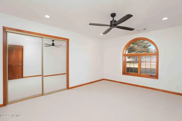 a view of an empty room with a fireplace and a window