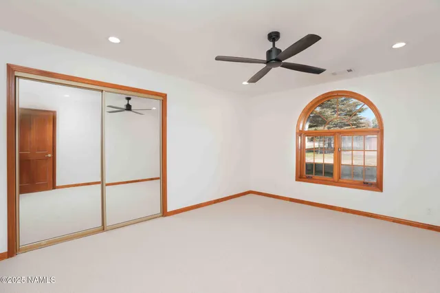 a view of an empty room with a fireplace and a window