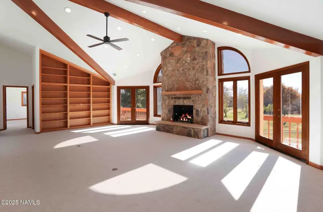 a bathroom with a granite countertop toilet a sink and a large mirror