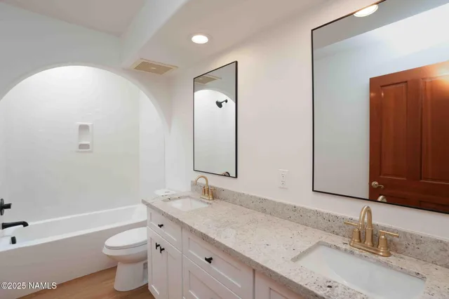 an empty room with a window and a ceiling fan