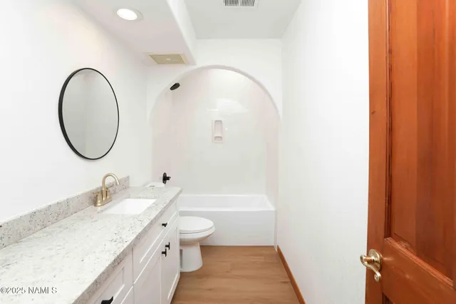 a view of a livingroom with a ceiling fan and window