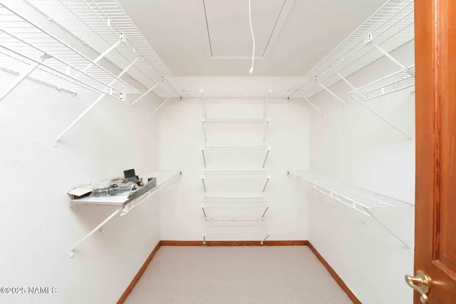 a view of a house with backyard and trees