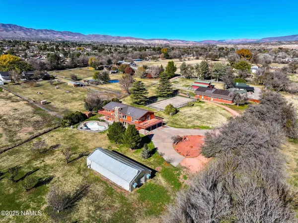 an aerial view of residential houses with outdoor space