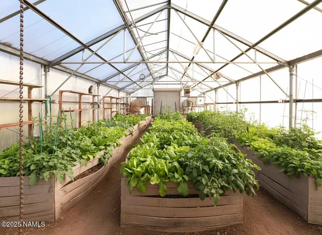 a kitchen with stainless steel appliances a refrigerator a sink a stove and white cabinets