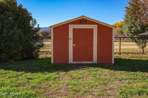 a workspace with furniture and a refrigerator