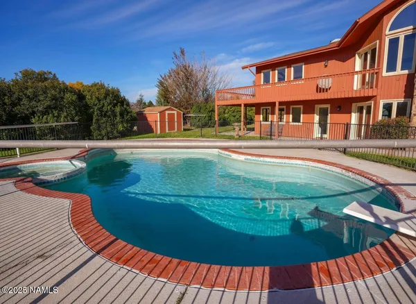 a spacious bedroom with a bed and a chandelier