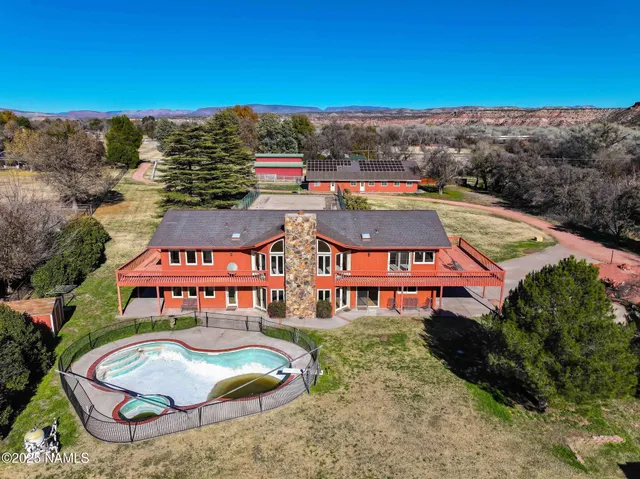an aerial view of a house with a yard