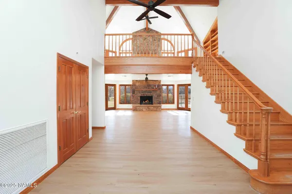 a view of an empty room with a fireplace and a window