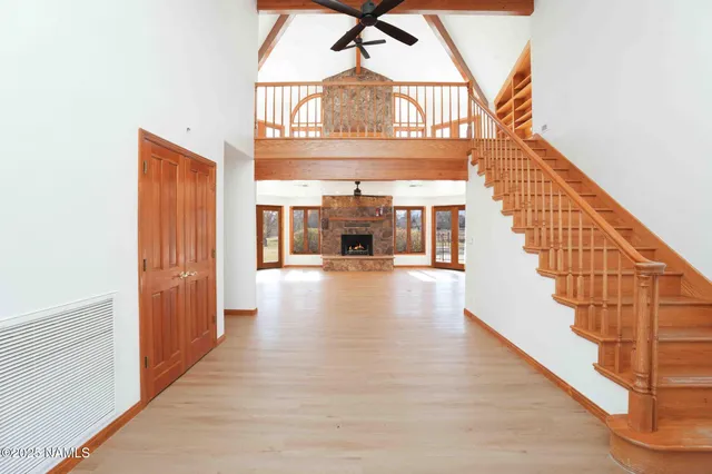 a view of an empty room with a fireplace and a window