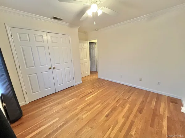 a view of empty room with wooden floor