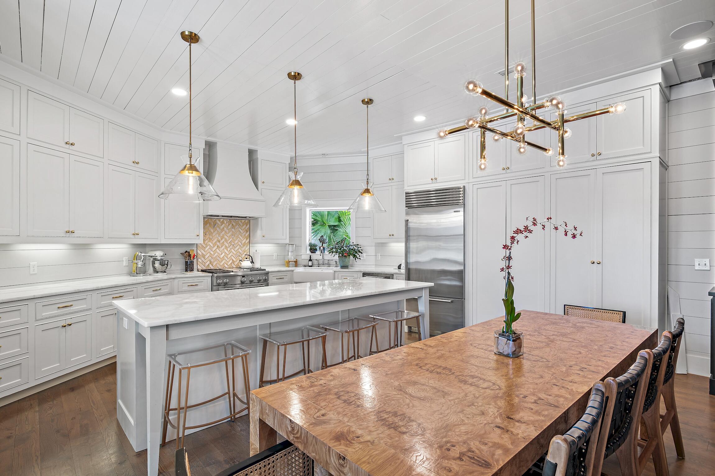 87 Bullard Road Santa Rosa Beach, FL 32459 - Photo 11 of 37 a kitchen with stainless steel appliances granite countertop a stove a sink a refrigerator a center island a stove and a cabinets