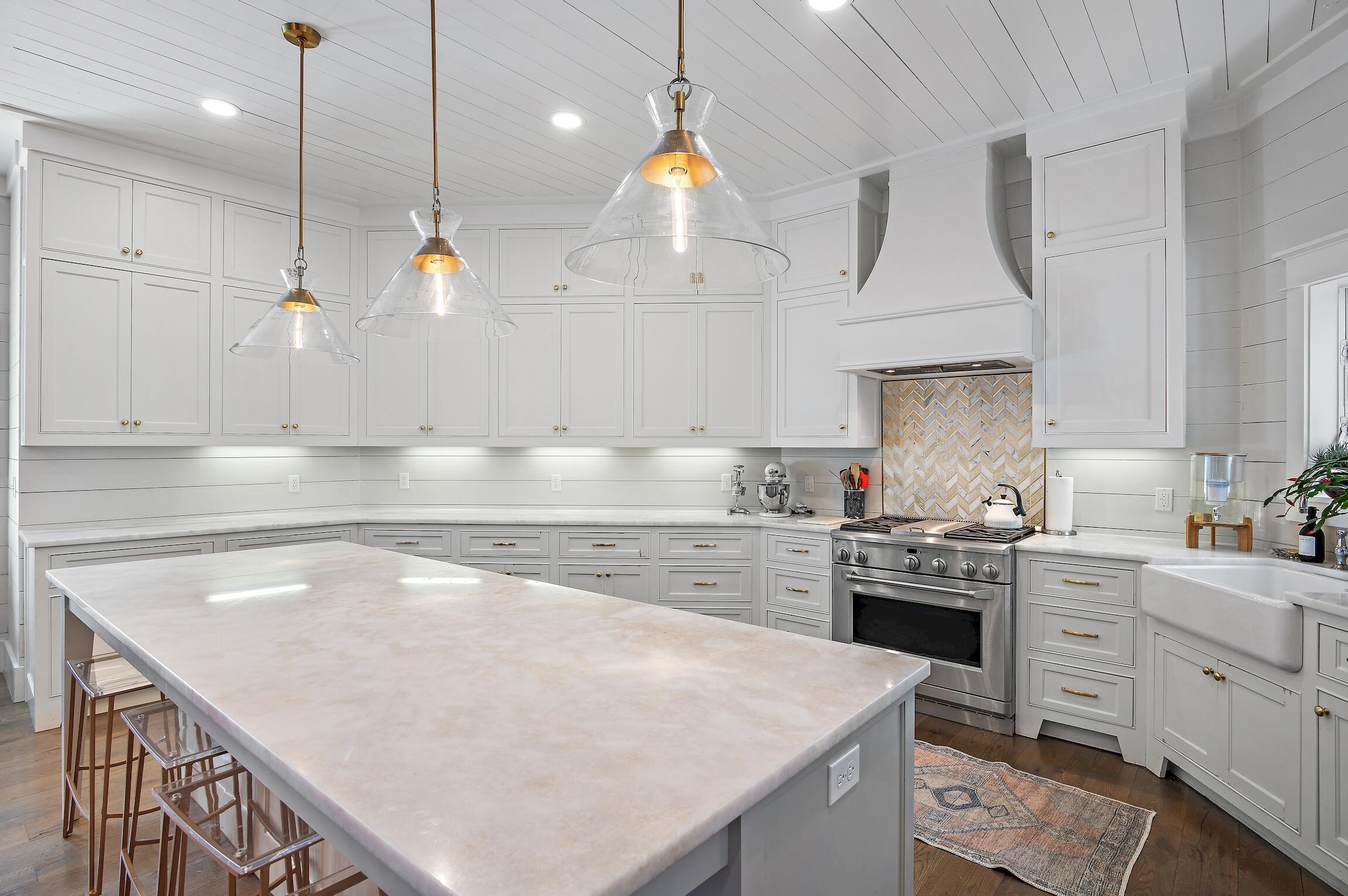 87 Bullard Road Santa Rosa Beach, FL 32459 - Photo 13 of 37 a kitchen with kitchen island a stove a sink a center island and wooden cabinets
