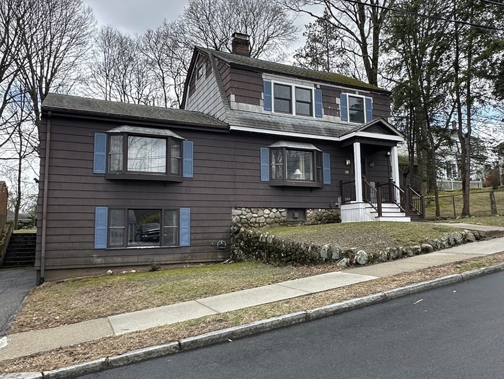 38 Byron Street, Unit 2 Wakefield, MA 01880 - Photo 1 of 10 a front view of a house with a yard garage and glass windows