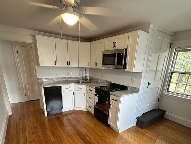 a kitchen with a stove a sink and a microwave
