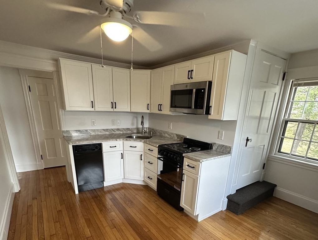 38 Byron Street, Unit 2 Wakefield, MA 01880 - Photo 2 of 10 a kitchen with a stove a sink and a microwave