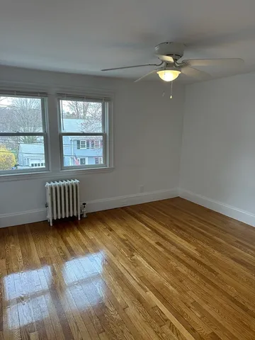 a view of a room with wooden floor and windows