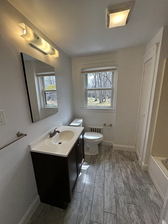 38 Byron Street, Unit 2 Wakefield, MA 01880 - Photo 8 of 10 a bathroom with a toilet sink and mirror