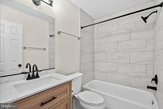 a bathroom with a sink a toilet and bathtub