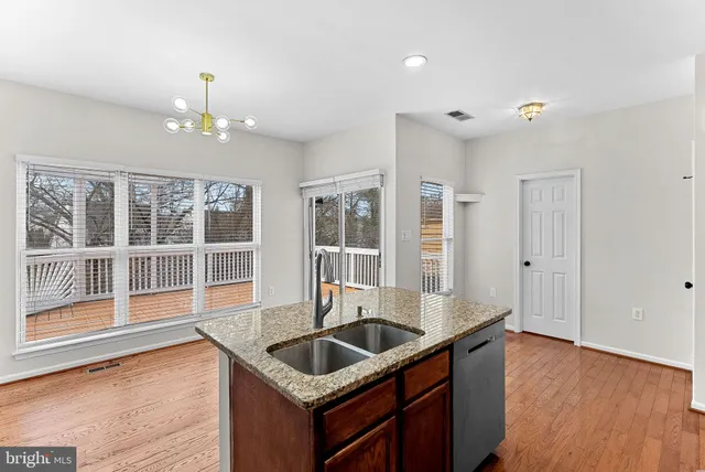 a kitchen that has a sink and a wooden floor