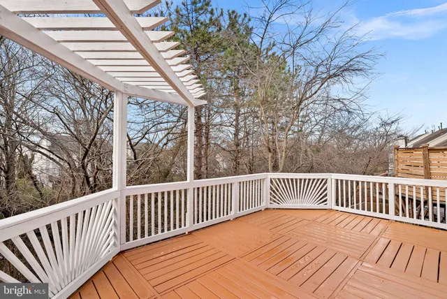a balcony with wooden floor and fence