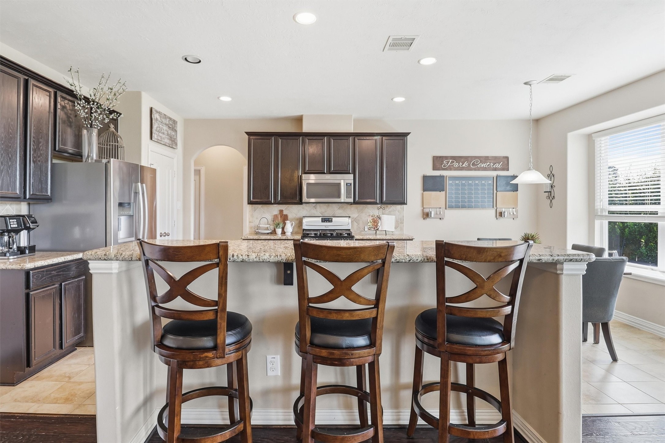 3219 Cotton Ranch Drive Katy, TX 77494 - Photo 10 of 45 Gather around the oversized breakfast bar, where generous granite countertops provide ample seating for morning coffee, quick meals, or conversation while the chef is at work.