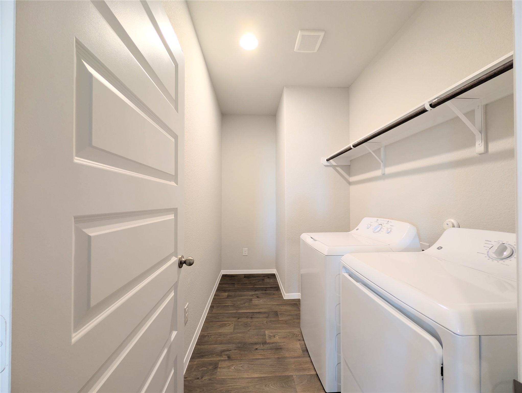 5524 Sacra Cove Austin, TX 78747 - Photo 12 of 37 Laundry area with dark wood-style flooring and washer and clothes dryer