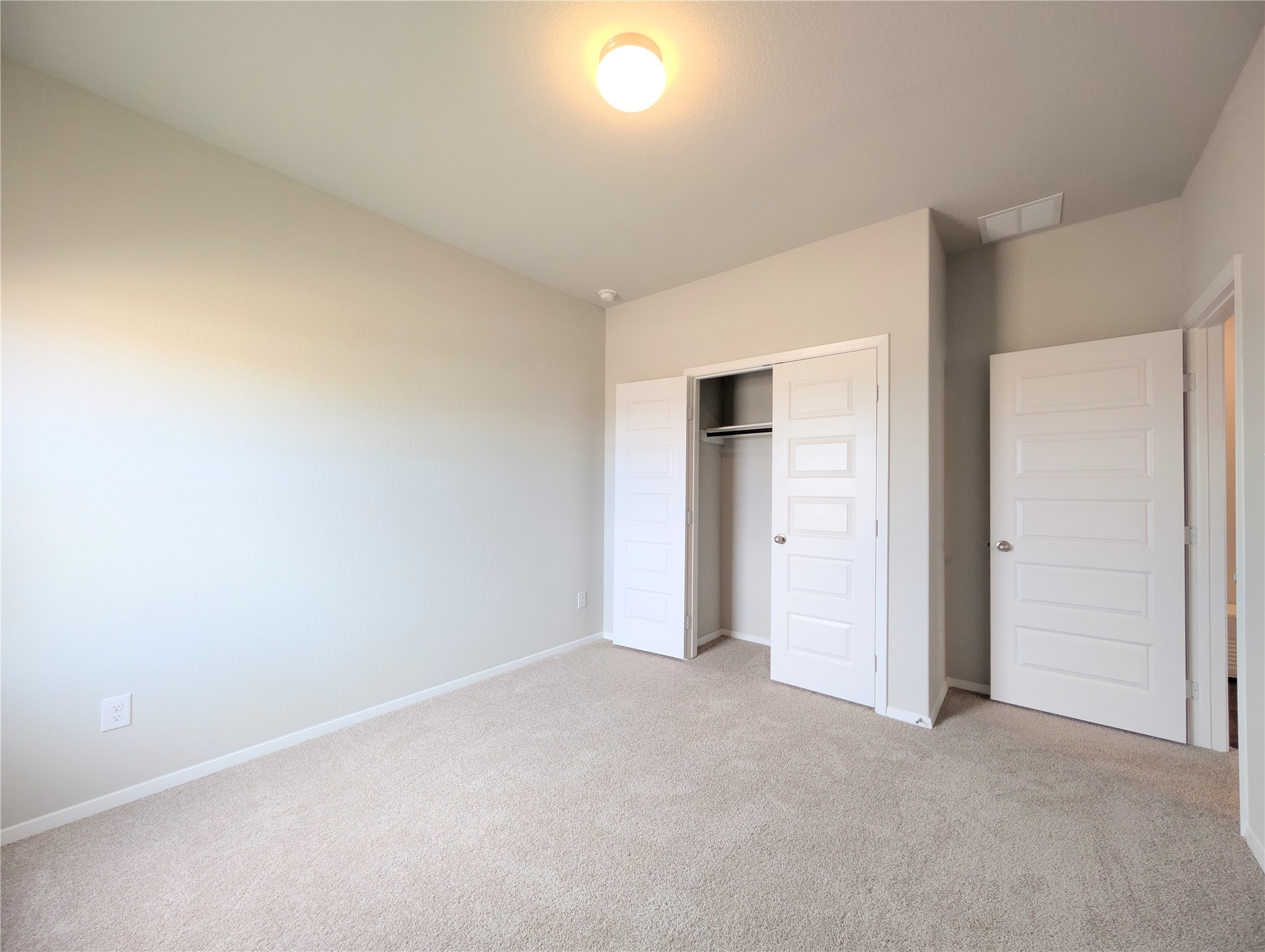 5524 Sacra Cove Austin, TX 78747 - Photo 16 of 37 Unfurnished bedroom with light colored carpet and a closet