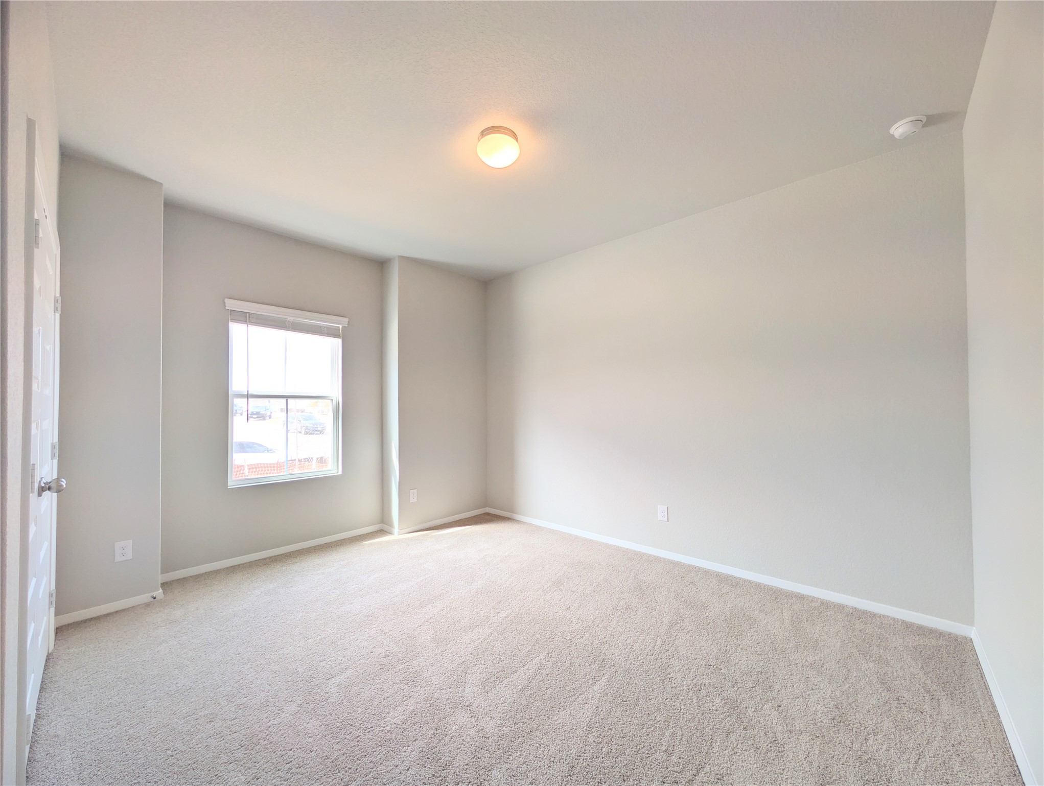 5524 Sacra Cove Austin, TX 78747 - Photo 17 of 37 Unfurnished bedroom with light carpet & walls