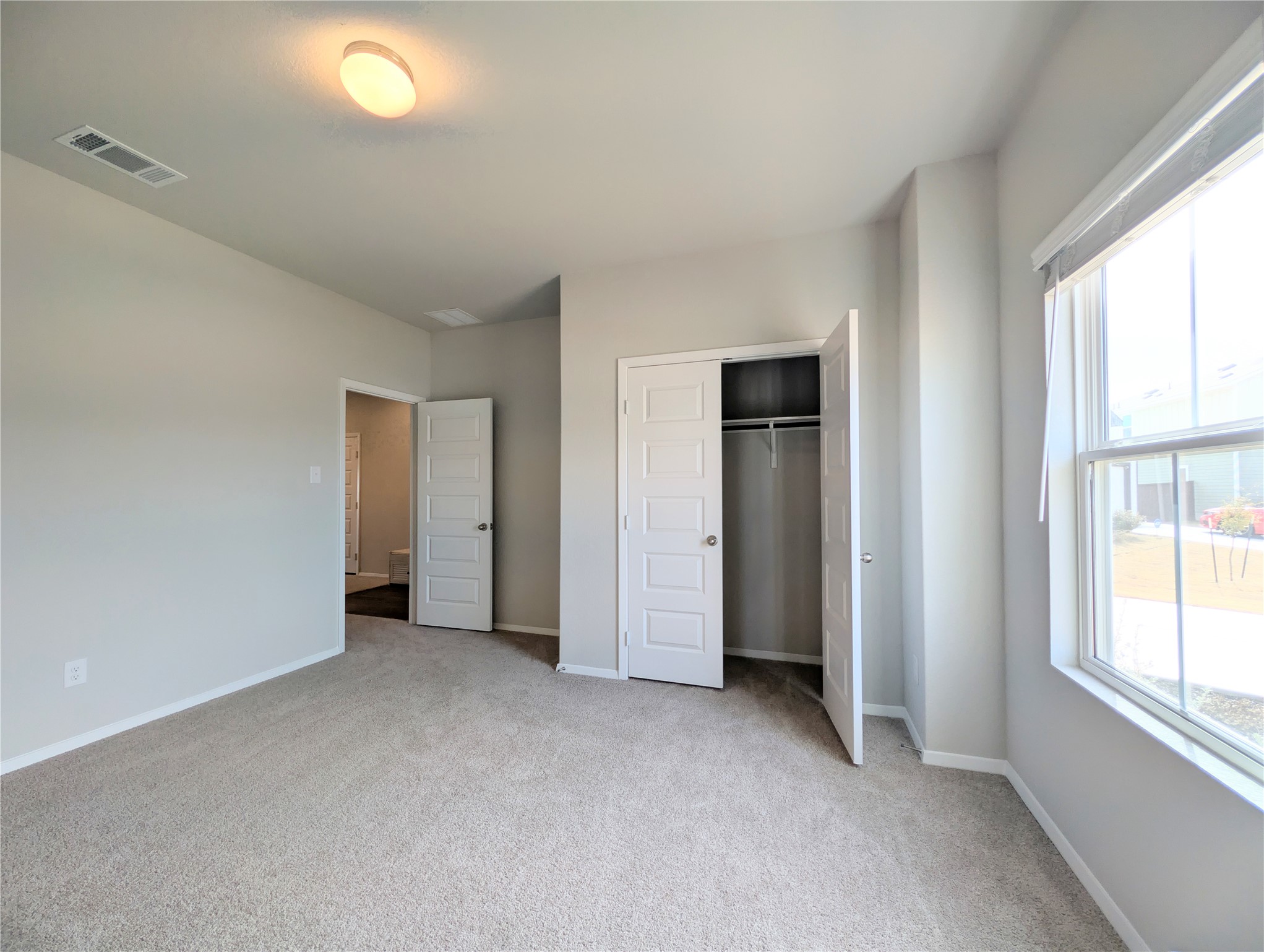 5524 Sacra Cove Austin, TX 78747 - Photo 18 of 37 Unfurnished bedroom featuring light colored carpet and a closet